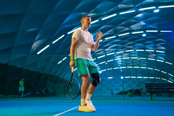 Man playing tennis on a court