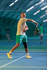 Fototapeta premium Man playing tennis on a court