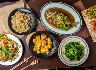 Delicious Asian Cuisine Spread with Fried Fish, Tofu, Vegetables, Fried Rice, and Shrimp on Dining Table top view