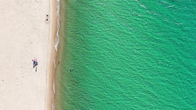 Minimal 4K aerial view of Saros Bay beach in Enez, Edirne, Turkey. Crystal-clear turquoise water, clean sandy shore, and a peaceful scene with few people. Ideal for nature, travel, and drone footage u