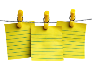 Three yellow lined note papers hanging on a clothesline with yellow clips