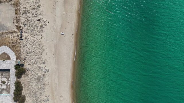 4K drone view of Saros Bay coast in Enez, Edirne, Turkey. Crystal-clear turquoise sea, empty sandy beach, and historical ruins nearby. Ideal for nature, travel, and aerial stock footage use.

