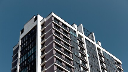 highrise building with glass facade and balconies in downtown metropolis. Contemporary multistorey
