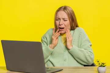 Displeased middle-aged woman using laptop notebook typing working, loses becoming surprised sudden...