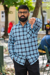 Dislike. Upset Indian bearded man showing thumbs down sign gesture, expressing discontent...