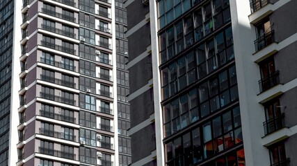 Closeup view of tall modern residential building with multiple windows and contemporary facade in