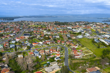 Drone aerial photograph of the town of Lake Heights with Lake Illawarra in the background in the...