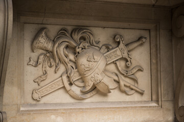coat of arms, a detailed, carved stone bas-relief, which appears to be a decorative element on a...
