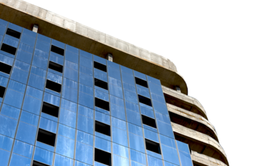 Highrise building under construction with steel framework and glass facade in modern city. Tall