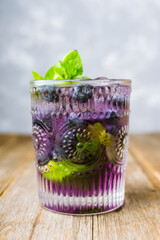 Blueberry mojito on the rustic wooden background. Selective focus.