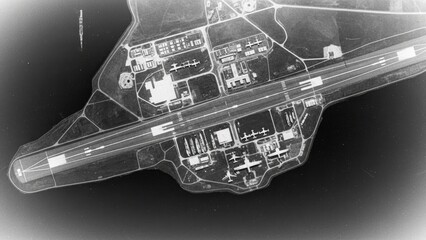 A tilted, vintage black and white aerial photo of a military airport.
