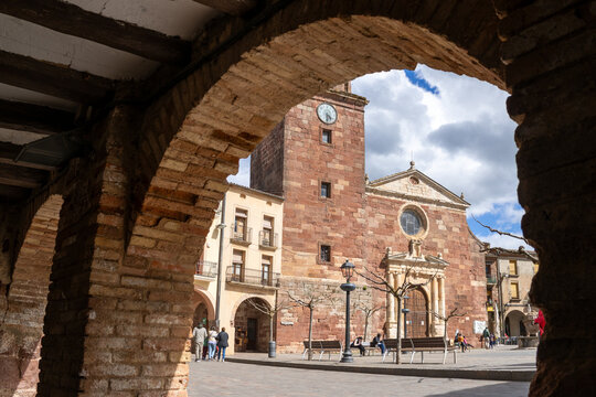 Main square of Prades with the Parish Church of Santa Maria, known as the Red Village for its reddish sandstone buildings, Tarragona, Catalonia, Spain.