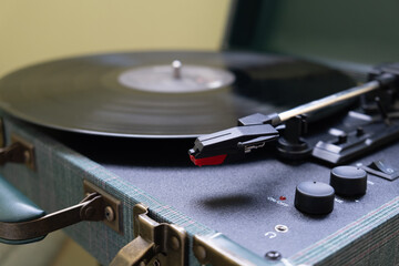 Close up of a spinning vinyl record on a turntable, evoking nostalgia and vintage atmosphere