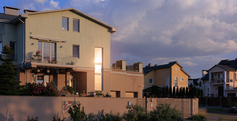 Fototapeta premium Cityscape on a sunny evening, modern buildings and houses 