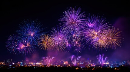 A fireworks display is lit up in the night sky, with a variety of colors and patterns. The fireworks are set off in a city, creating a festive atmosphere