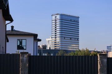 Cityscape on a sunny day, modern buildings and houses 