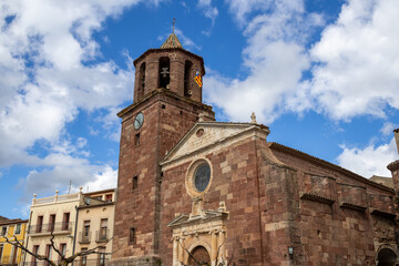 Main square of Prades with the Parish Church of Santa Maria, known as the Red Village for its reddish sandstone buildings, Tarragona, Catalonia, Spain.