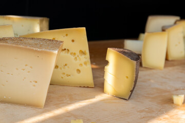 Assorted cheese varieties at a market stall