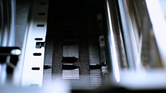 The process of printing a color inkjet printer in close-up. The rolles is rolling inside of device and printed a picture. A color calibration test. Print color chart for spectrophotometer.