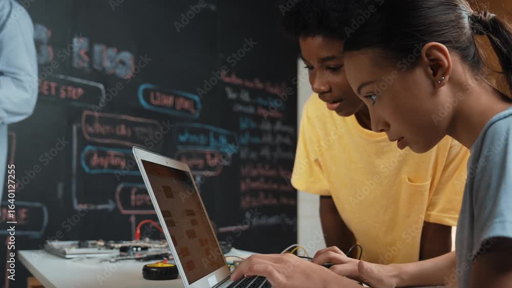 Poster happy african boy pointing at laptop screen while cute girl typing laptop coding or programming engi