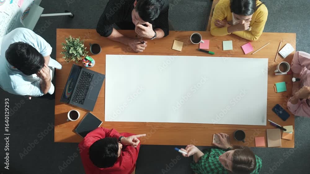 Poster time lapse of team designing and planning project at meeting table while pointing paper in meeting t