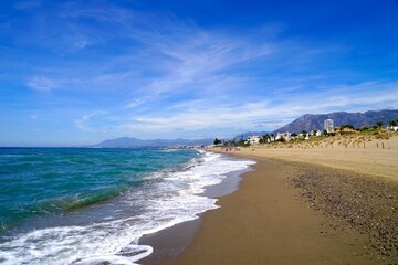 sandy beach at the Mediterranean Sea near Marbella, view along the Costa del Sol in the summer, Andalusia, Spain