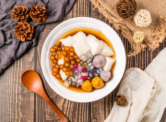 Almond Tofu Pudding with Taro Balls, Sweet Potato Balls, and Tapioca Pearls in bowl top view of Taiwan food