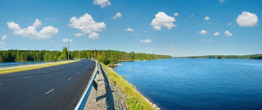 The road along summer lake (Finland). Panorama.