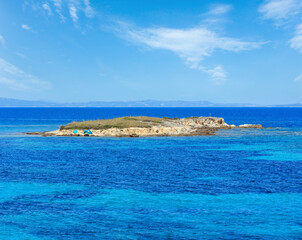 Aegean sea coast landscape with rocky island, view near Karidi beach (Chalkidiki, Greece).