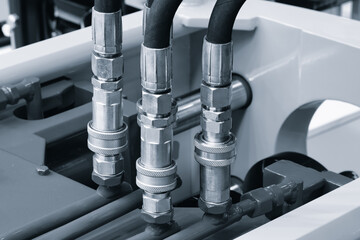 Bundle of pipes connected to industrial hydraulic pneumatic machine, industrial concept background