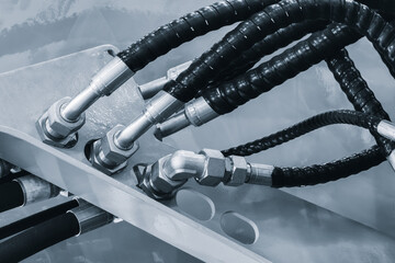 Bundle of pipes connected to industrial hydraulic pneumatic machine, industrial concept background