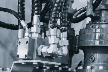 Bundle of pipes connected to industrial hydraulic pneumatic machine, industrial concept background