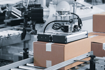 Robotic warehouse line for packing orders into cardboard boxes, packaging and logistics concept background