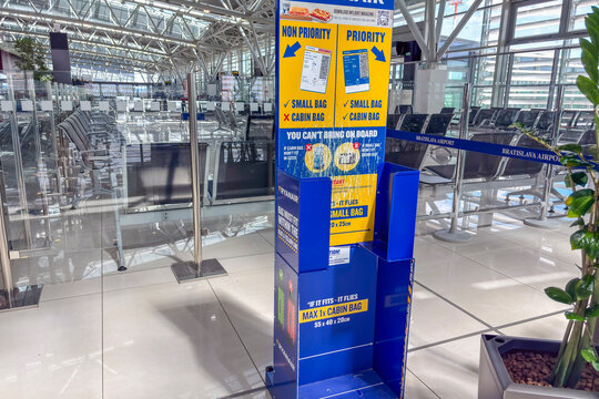 August 2, 2025, Slovakia, Bratislava: ryanair blue and yellow baggage sizer stand in a modern empty airport terminal with signs for cabin bag rules concept of airline company, travel agency, logistics
