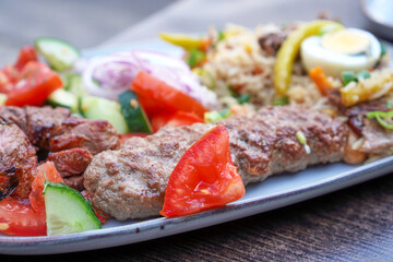 Kebab with rice and vegetables on a plate
