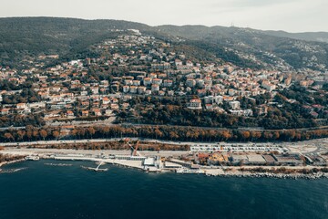 Fototapeta premium Aerial view of a coastal city with hills.