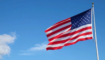 American flag flying proudly in the wind, clear blue sky with soft white clouds,
