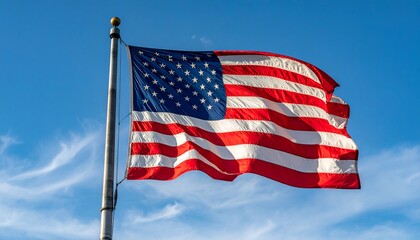 American flag flying proudly in the wind, clear blue sky with soft white clouds,