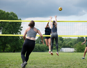 Volleyball player does a roll cut shot over the block