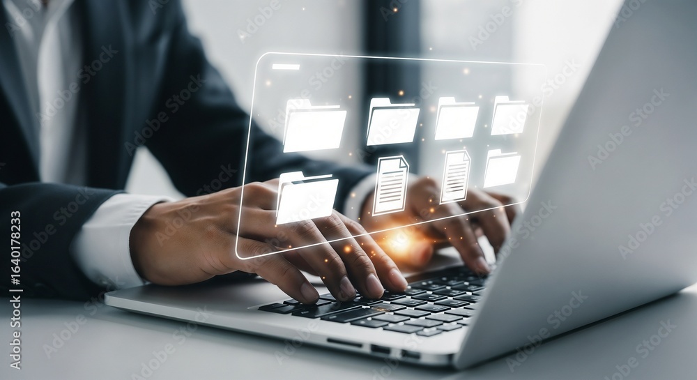 Poster a person in a suit working on a laptop displaying a holographic user interface of files and folders.