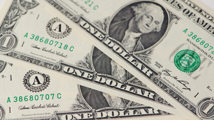 Currency display featuring one dollar bills on a flat surface