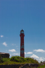 red lighthouse against blue sky