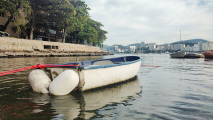 Urca neighborhood hill beach sea ocean deck texture pattern stone wall wood shell boat dinghy sailboat landscape happy life beautiful pleasant comfort vacation buoy sun cloud blue sky reflection shine