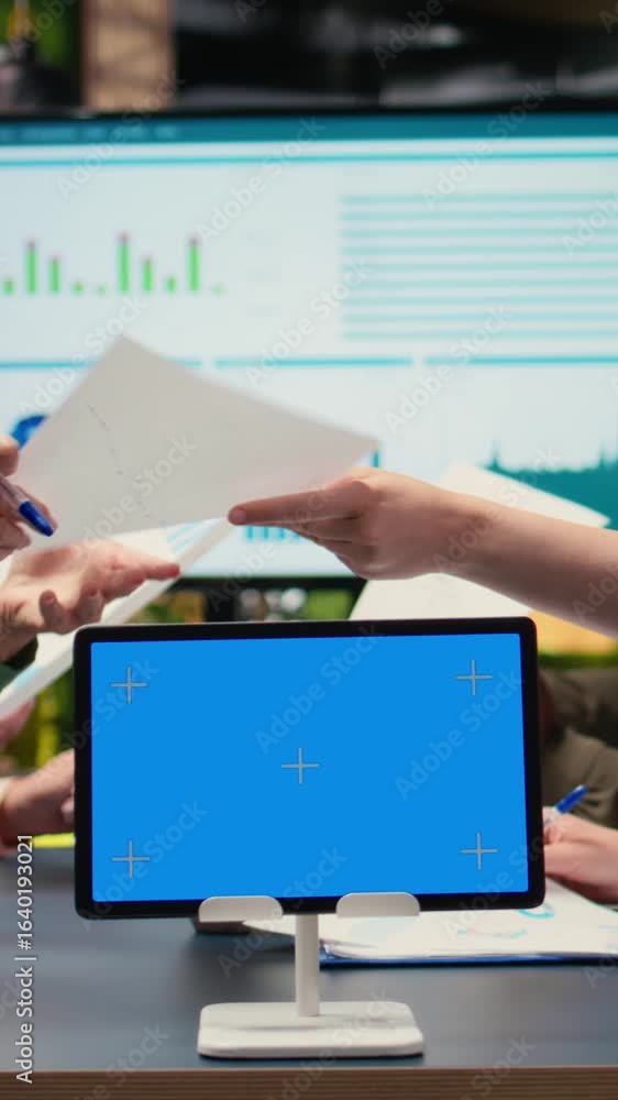 Poster vertical video multiethnic team of businesswomen with a mockup display gather in meeting, discuss pr