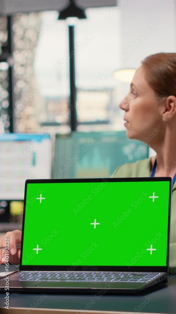 Poster vertical video powerful businesswomen using a laptop with isolated display, exchanging reports and s