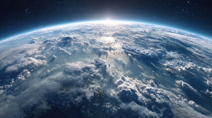 This breathtaking view captures Earth from above, revealing a vast expanse of clouds illuminated by the early morning sun. The scene evokes a sense of wonder and tranquility.