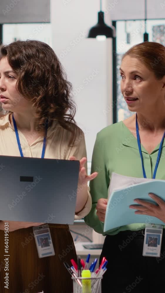 Poster vertical video career focused businesswomen reviewing analytics and aligning objectives, empowered b