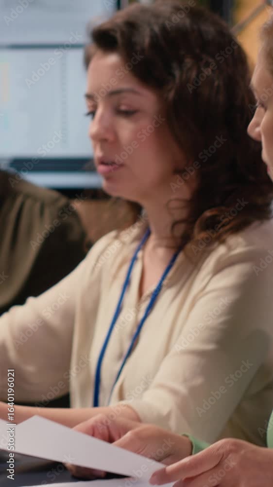 Poster vertical video empowered businesswomen evaluating graphs and strategy reports in a forward thinking 