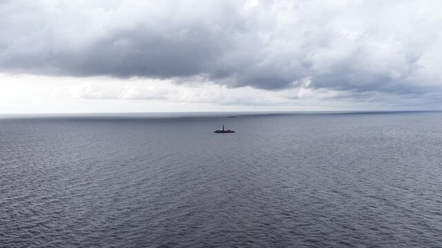 Aerial view of Kolka Lighthouse standing on a small fortified island in the Baltic Sea, surrounded by open water and seabirds, serving as a maritime navigation aid off Latvia&rsquo;s coast.