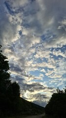 in the evening, sunset, beautiful clouds in the blue sky, summer season, nice summer weather